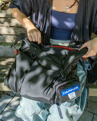 Black tech sateen Cloud hobo bag open top; front pocket with HAPPIER tag