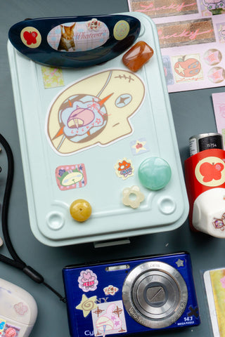 Light blue toolbox decorated with stickers and a camera