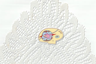Colorful skull head sticker on a white lace background