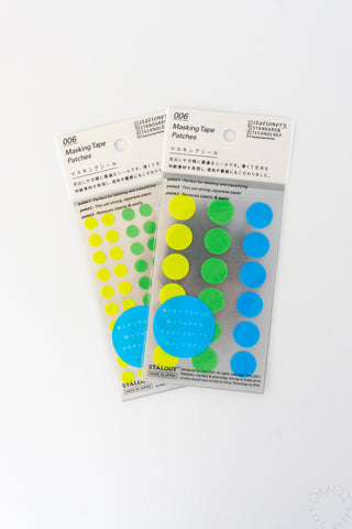 Two green washi dot stickers on a white background