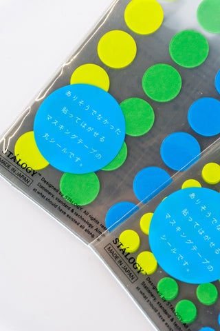 Close up of green washi dot stickers on a white background