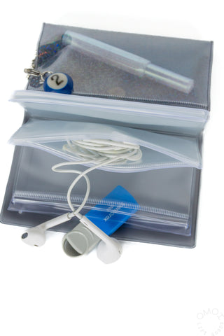 Opened black holographic 5 pocket pouch with earbuds and flashdrive on a white background