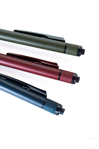 Close-up of three Tombow MONO Graph Tune mechanical pencils in green, red, blue