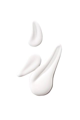 Three white cream swatches on a white background