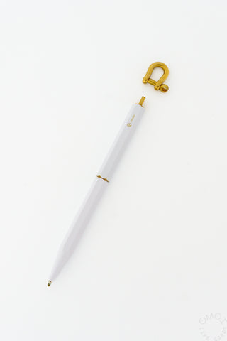White ystudio pen with brass hook on a white background