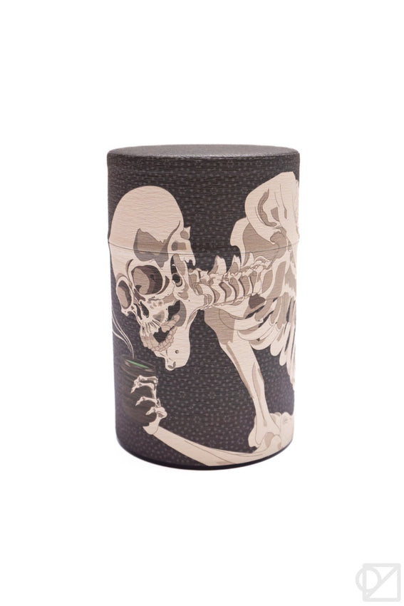 Dark tea canister with silver top and ukiyo-e style skeleton illustration