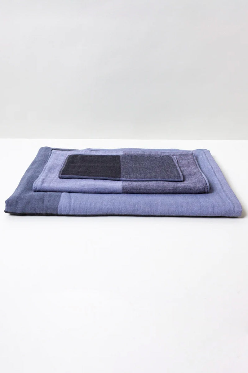https://omoionline.com/cdn/shop/products/Morihata-Yoshii-Chambray-Block-Towel-Grey-Black-1.jpg?v=1685726810